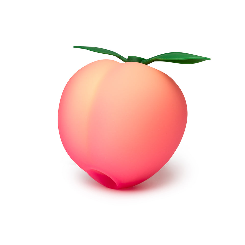 ROMP Pink Peach stimulator held in hand for scale