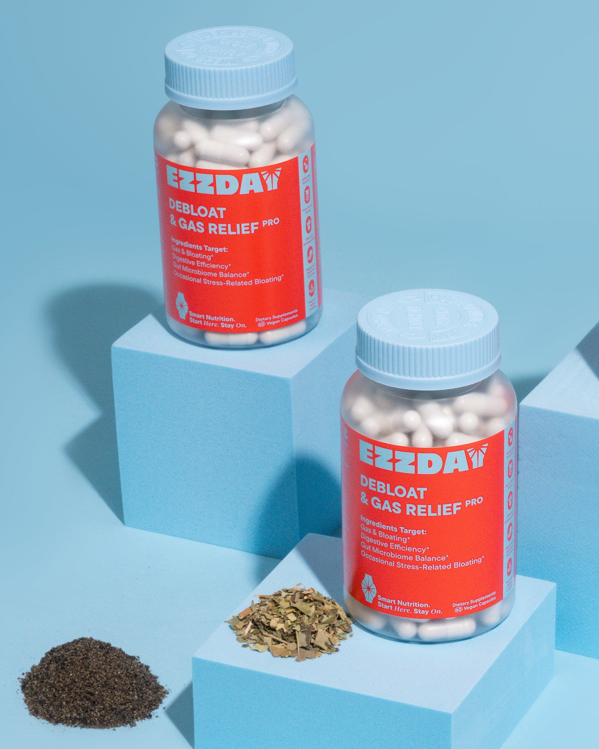 Two bottles of EZZDAY Debloot & Gas Relief Pro on a blue background with herbs.